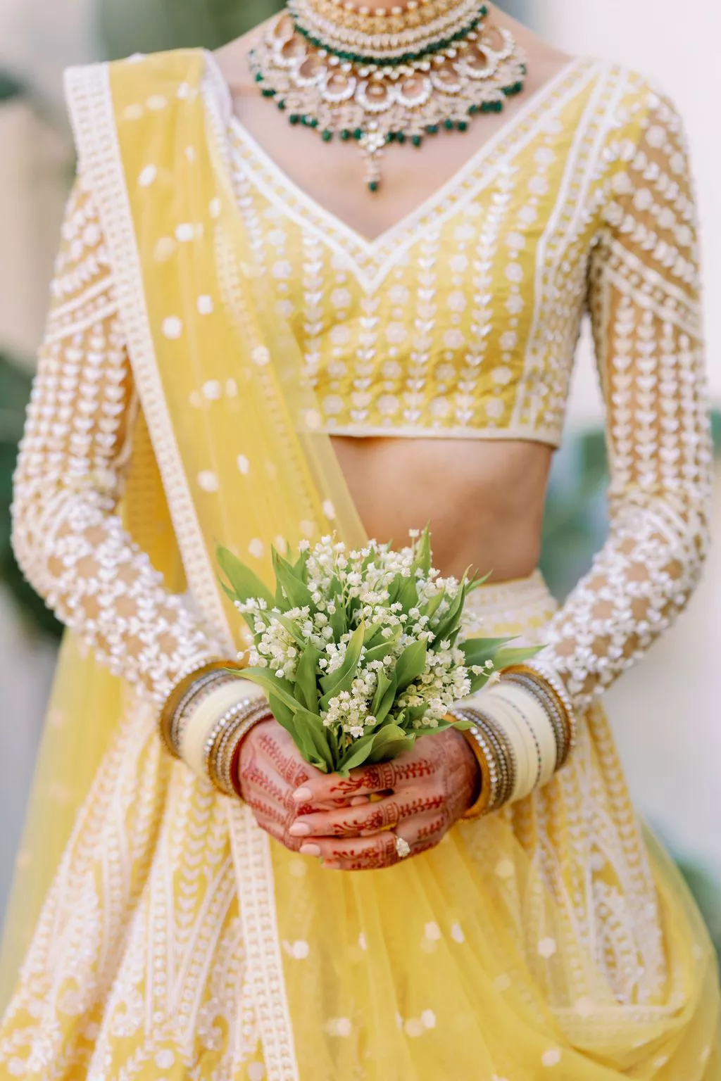 Single flower lily of the valley bridal bouquet at an Indian wedding.